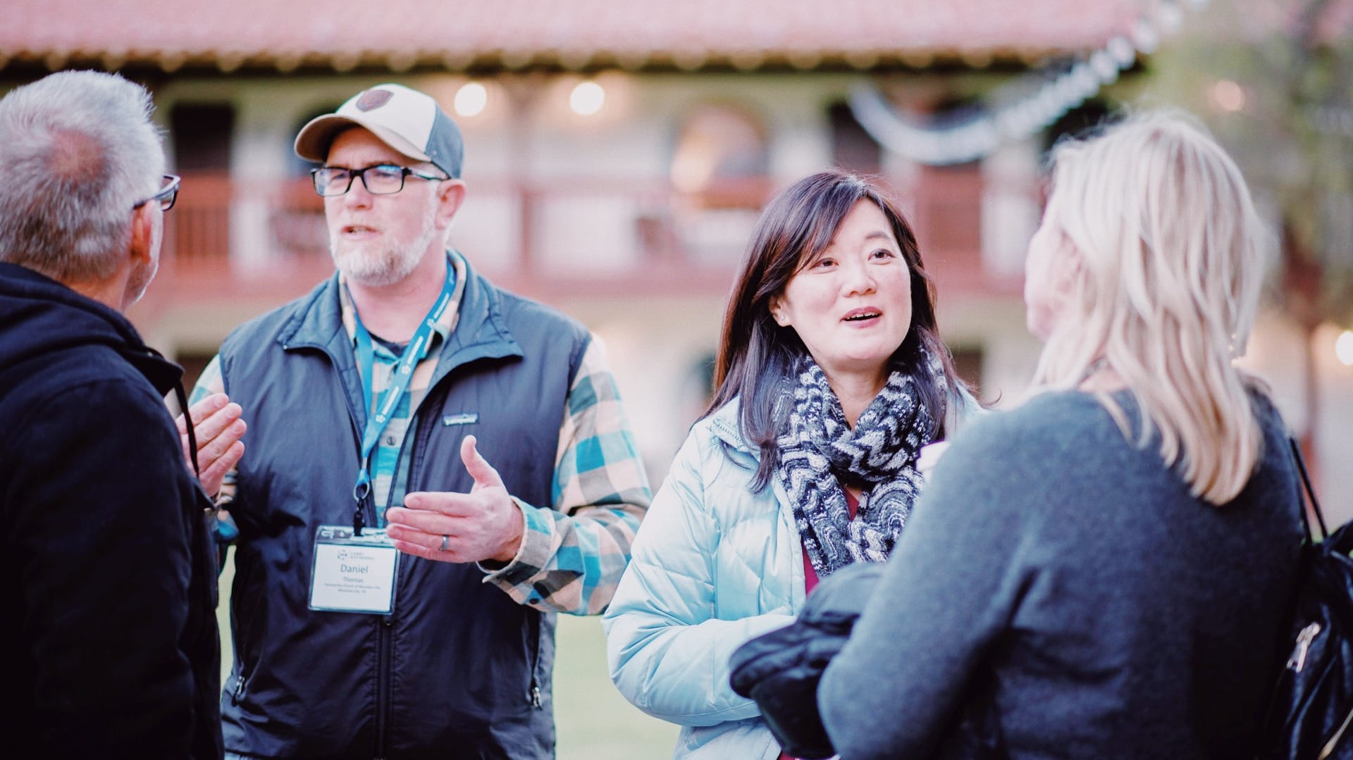 Sailfin Charity Consultancy. Photo of four people talking in a small group outside.